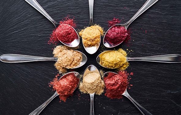 8 spoons, each containing a flavor from the Toofruit range - dehydrated fruit concentrates