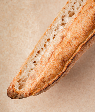 A close-up photo of a baguette on a sourdough-based background