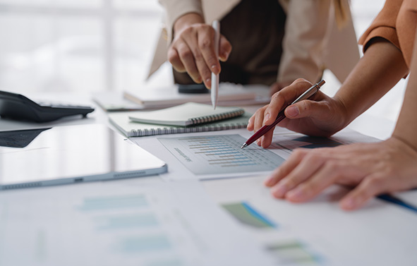 Two people discussing reports and follow-ups.